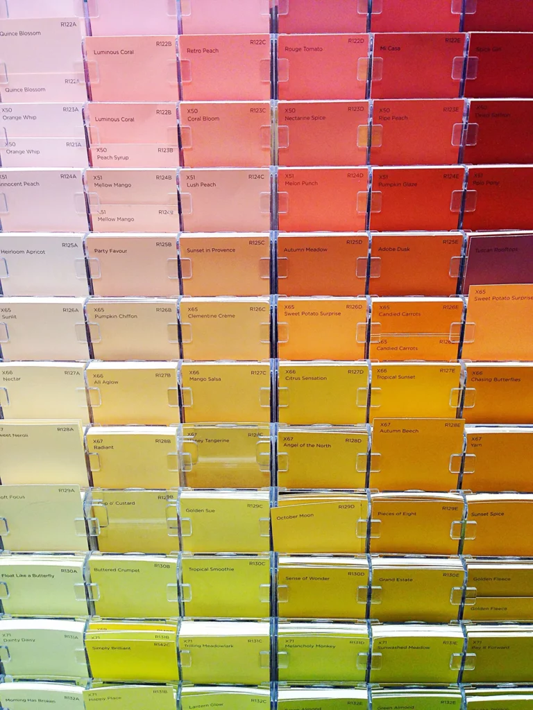 A row of different colored paint swatches in a store.